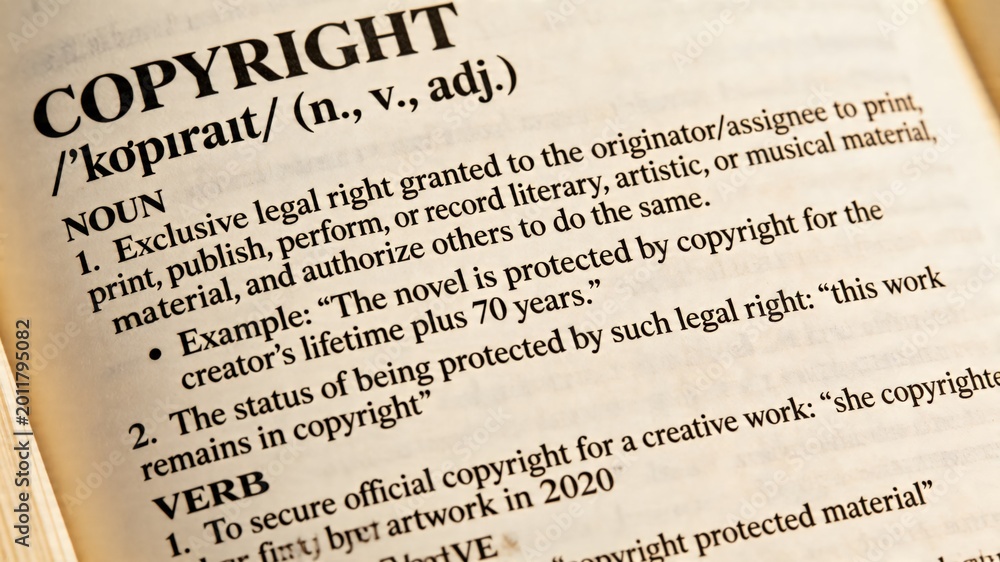 Fototapeta premium This shows a close-up view of a dictionary page that provides a detailed definition of the term copyright, emphasizing its relevance to intellectual property rights and legal protections for creative