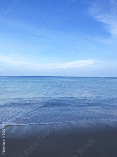 Photography Calm blue sea horizon, gentle waves lapping sandy shore, tranquil coastal scene