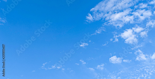 Vast blue sky with thin wispy white clouds during daytime.