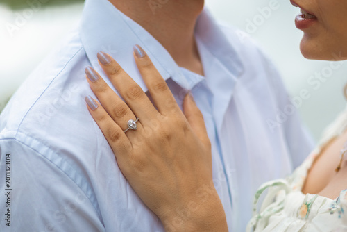 Fotografie Close up of engagement ring on woman's hand