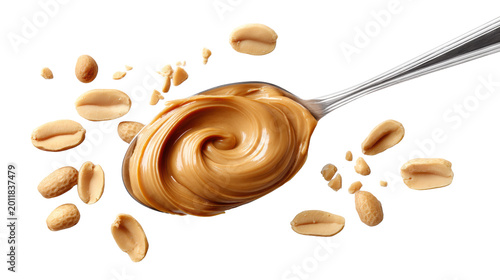Stainless steel spoon with creamy peanut butter swirl and scattered roasted peanuts isolated