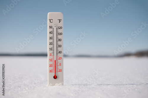 Celsius and fahrenheit scale thermometer in snow. Ambient temperature minus 8 degrees celsius