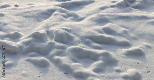 Obraz na plátne small drifts of soft snow after a snowfall, the uneven structure of the snow is
