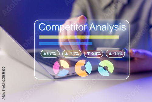 Data analysis on a laptop screen showing competitor statistics and performance metrics in a modern workspace environment