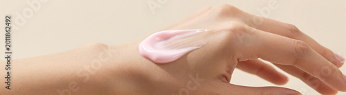 gentle pink hand cream spreading evenly woman palm creating soft wavy textures natural daylight subtle