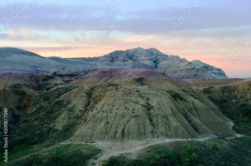 Photography A painted sky rises over the painted mounds of Badlands National Park