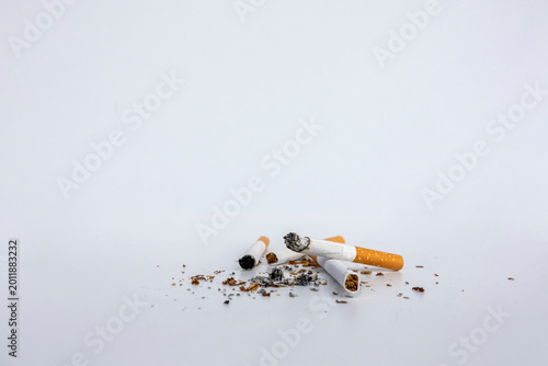 Broken Cigarettes and Ash on White Background Smoking Addiction Health Risk Concept