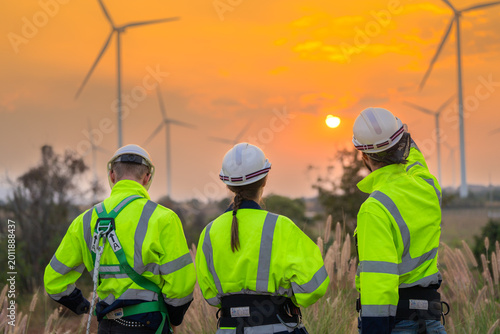 Tableau sur toile Team Engineers men and woman checking and inspecting on construction with sunset sky