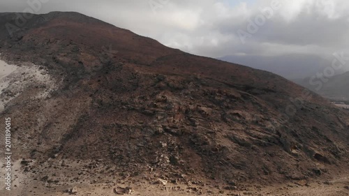 Aerial video flight over a deep rocky canyon and dry mountain valley on socotra island yemen, perfect for rugged nature travel documentaries, exotic wilderness exploration or desert backgrounds