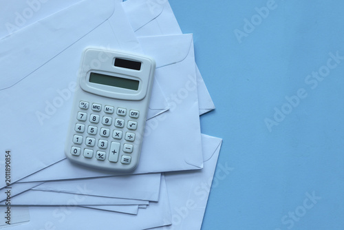 close up top view on calculator and open over calculator and group of invoice letter mail and from bank on beige table background for money and debt management concept