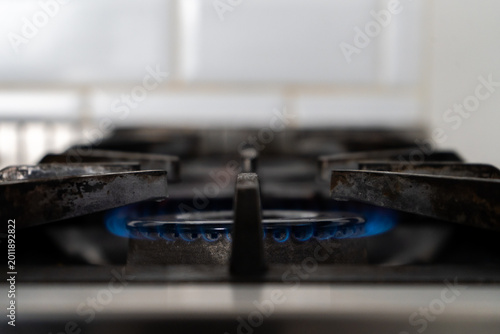 Fotografie ndustrial gas stove burner with blue flame in professional restaurant kitchen in