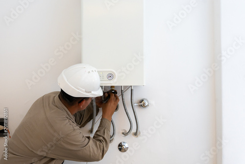 Cuadro en lienzo Gas water heater boiler installed in domestic kitchen near window for safety ven