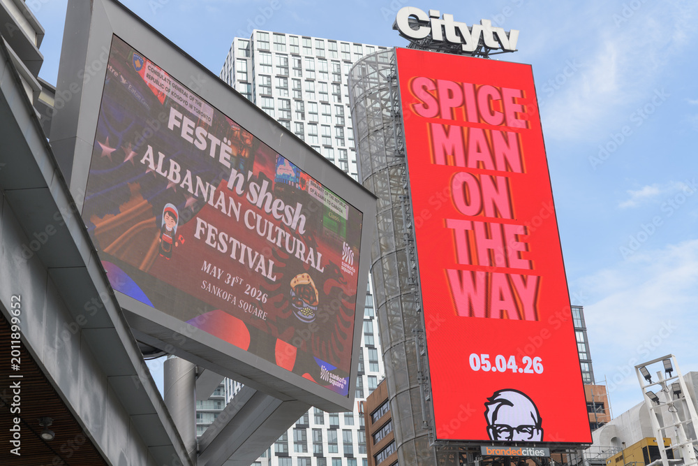 Obraz premium Citytv sign and narrow digital billboard featuring advertising for KFC fast food restaurants including community events announcements, Sankofa Square, Toronto