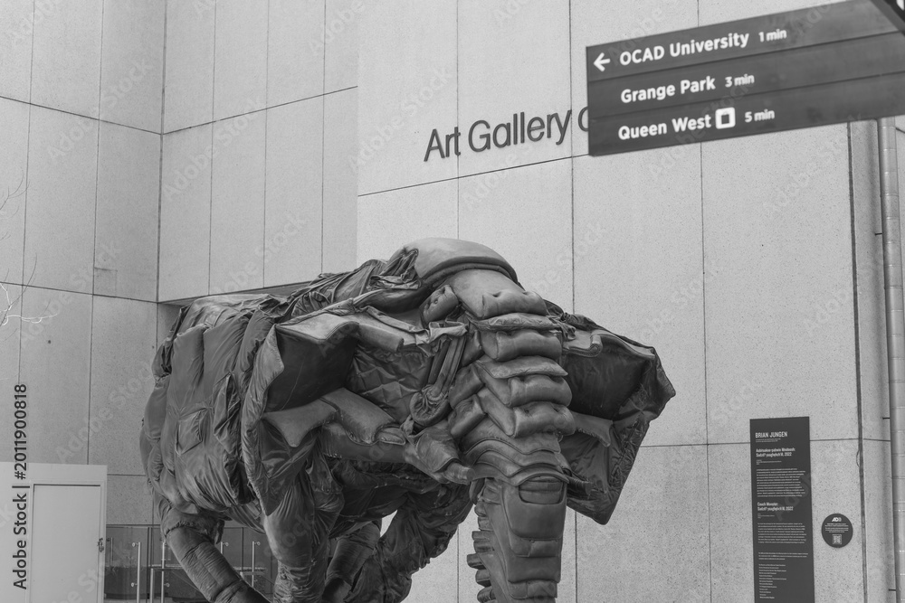Fototapeta premium black and white view of Couch Monster by Brian Jungen outside the Art Gallery of Ontario, 317 Dundas St W and McCaul St, Toronto
