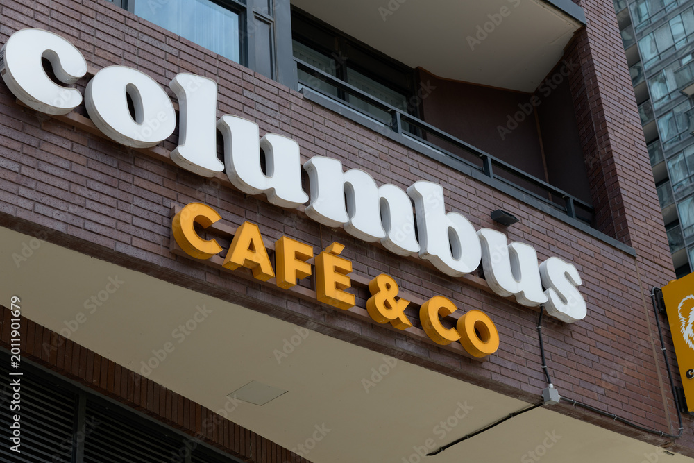 Obraz premium building exterior and sign of Columbus Café, a coffee shop chain, located here at 283 Adelaide St W, Toronto