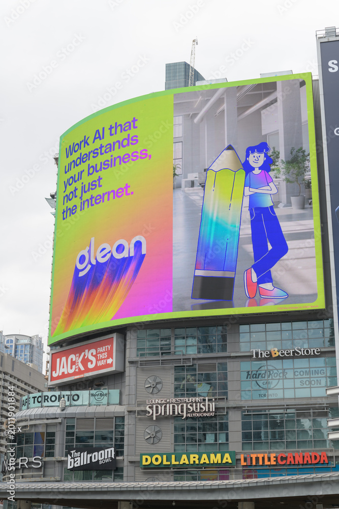 Fototapeta premium digital billboard featuring advertising for glean artificial intelligence on the exterior of The Tenor, a shopping mall, facing Sankofa Square, Toronto