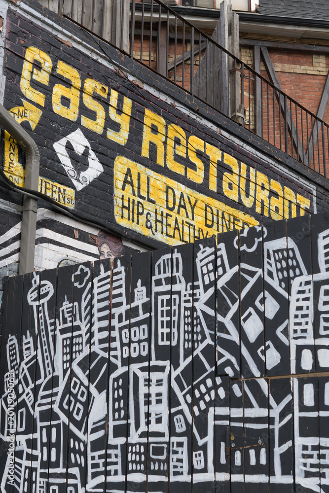 Naklejka premium funky signage outside Easy Restaurant located at 1645 Queen St W, Toronto