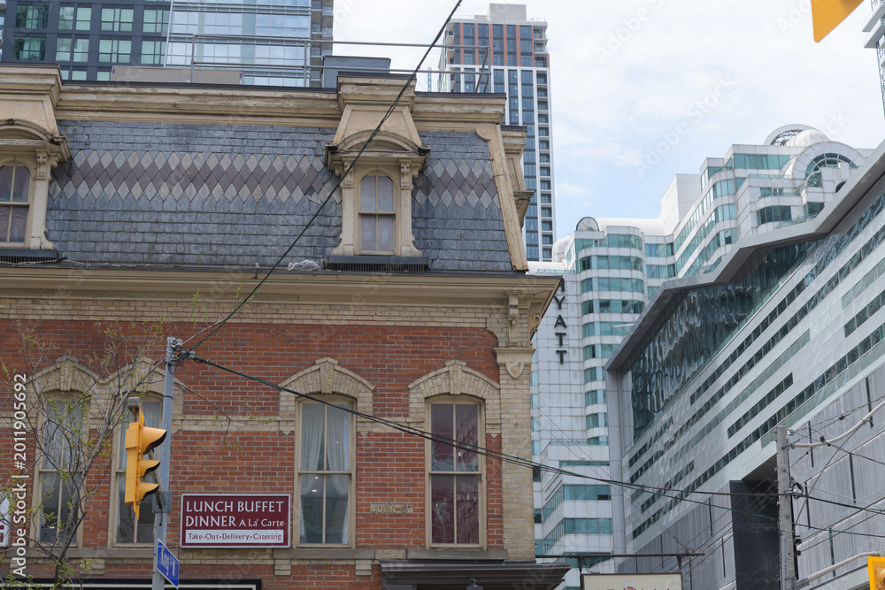 Fototapeta premium exterior of historic building (William Barber Building, 1880) and sign (Aroma Fine Indian Cuisine) - east elevation - 287-289 KIng St W, Toronto