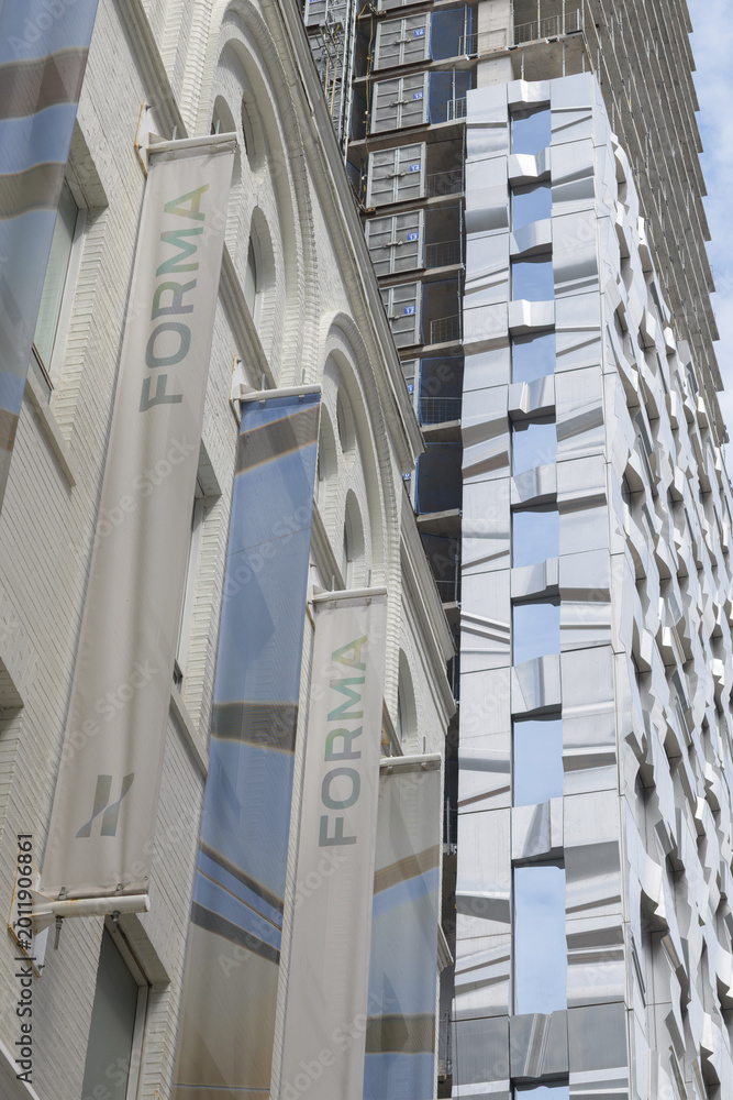 Obraz premium banner signs FORMA condos (east tower) designed by Frank Gehry at Duncan (Ed Mirvish Way) and King St W, features shimmering metal ribbons and glass, Toronto