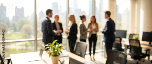 Professional team of business people having meeting near large glass window with city skyline background and natural light for corporate communication and team building concepts