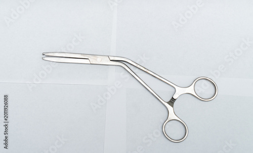 Obraz na płótnie Angled surgical forceps with notched tip on white background