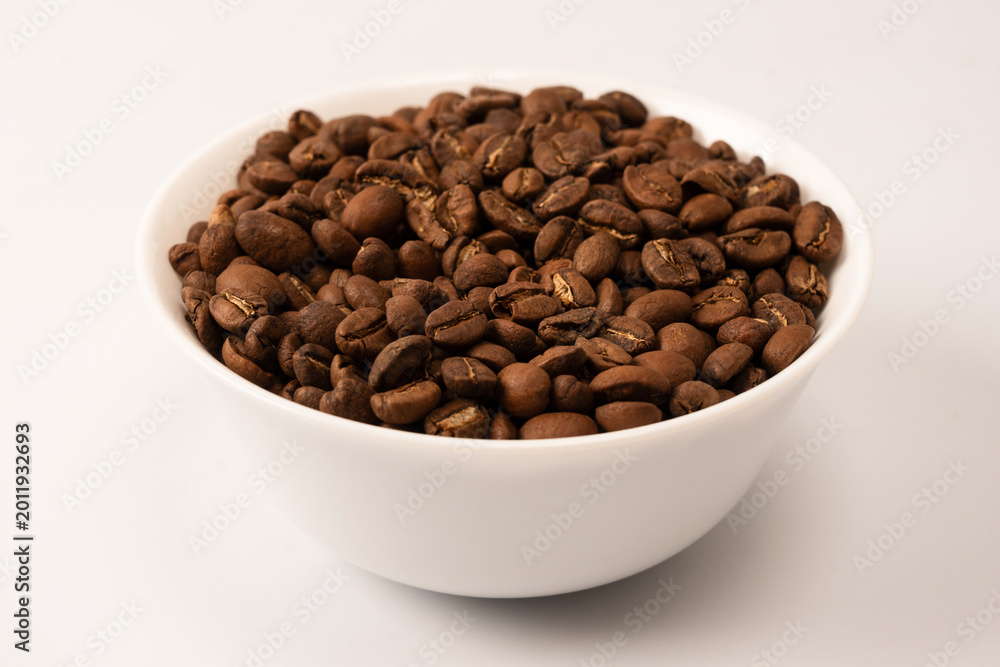 Fototapeta premium Coffee beans on a white background. Top view. Coffee beans texture.