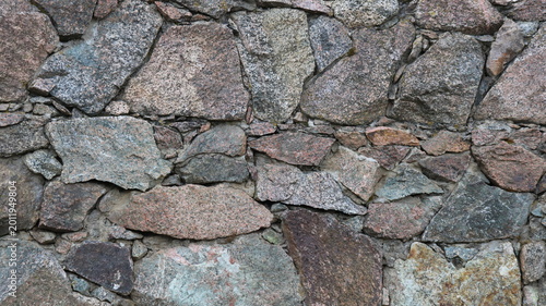 Bild auf Leinwand Beautiful unprocessed stonework made of solid granite boulders and small pebbles