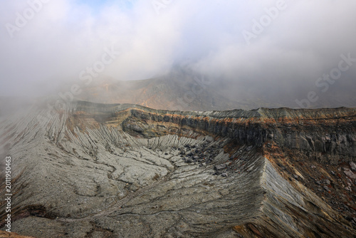 Photos View of the crater opening of erupting volcano