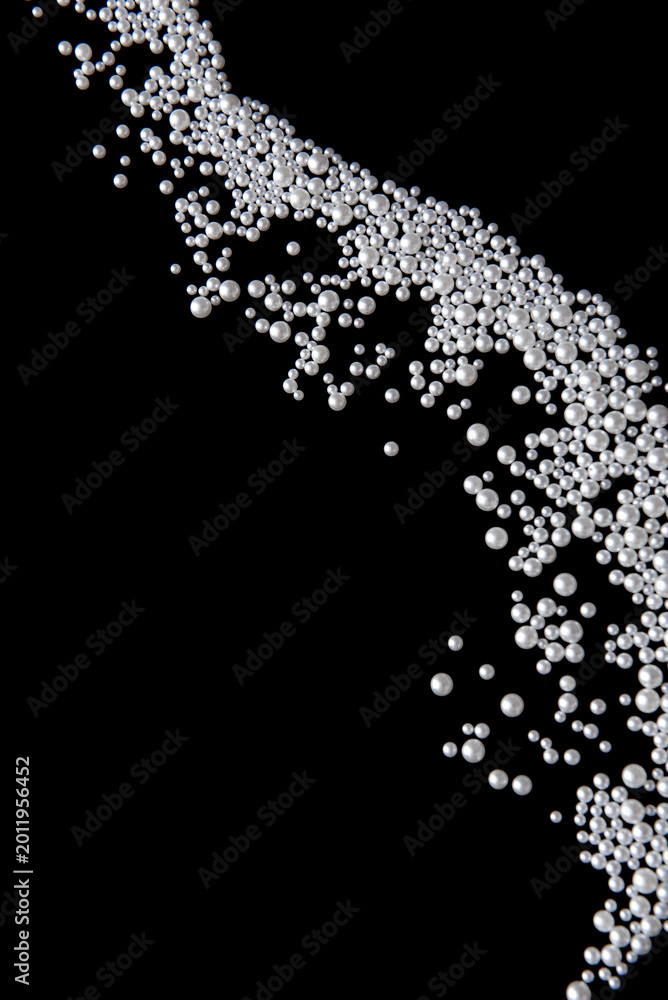 Fototapeta premium Beautiful pearls on black background. Luxury abstract composition with glossy pearl beads, minimal design, elegance and copy space
