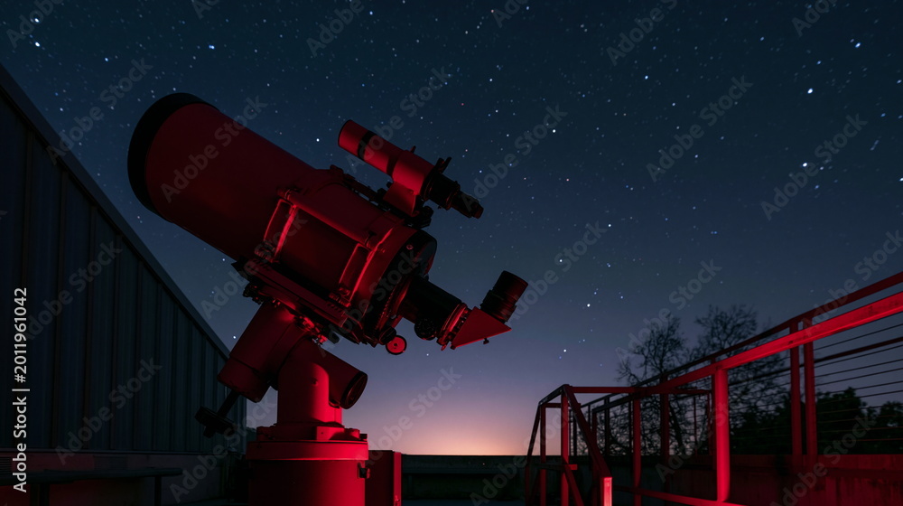 Fototapeta premium Astronomer Observing Stars Through Vintage Telescope at Remote Observatory Beneath a Star-Studded Night Sky