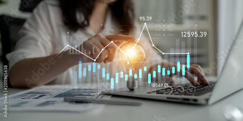 Photos A business professional engages with digital financial data, showcasing trends and ideas through technology for strategic investment and decision-making growth