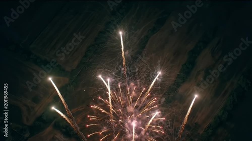 Cinematic 4K Slow Motion Red White and Blue Fireworks Exploding and Sparkling over Rural Landscape during Fourth of July Celebration