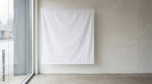 Large white fabric hanging on a wall next to a window