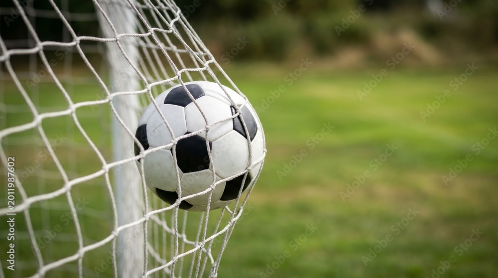 Naklejka premium Soccer ball hitting the net representing goal, success, and victory moment in football game