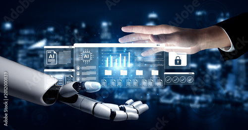 Canvas-taulu A conceptual image illustrating a seamless interaction between a human hand and a robotic hand, representing advanced technology and data visualization in a digitized environment