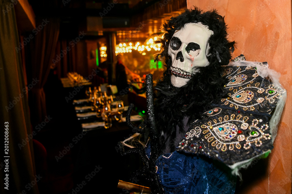 Fototapeta premium The atmospheric photography from the Halloween-themed event features a dramatic Halloween-inspired set, framed by spooky costumes, faux spider webs and mystical red lighting.
