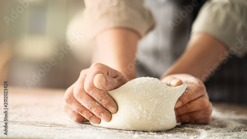 Photos Kneading dough at the kitchen table