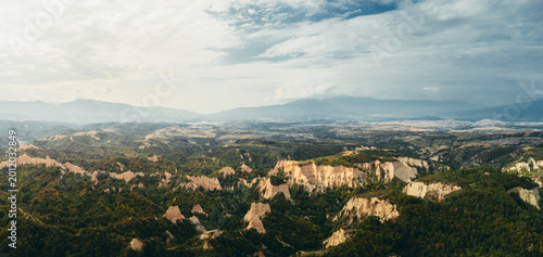 Photography High-resolution aerial landscape of unique sandstone rock formations surrounded by dense green forest and rolling hills