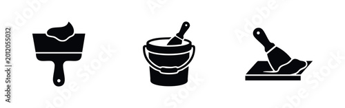 Billede på lærred Set of three black minimalist icons illustrating wall repair: a putty knife with plaster, a bucket of filler, and a spatula smoothing a surface