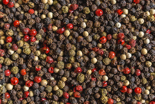 Fotografie blend of four types of aromatic peppers, delicious spices for cooking, a backgro