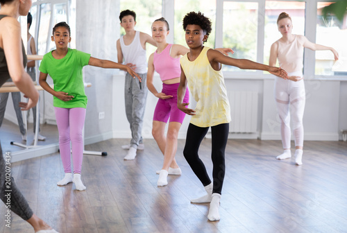 Fotografie Motivated african american teen boy participating in beginner group ballet class