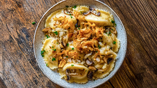 Quadro su tela Homemade pierogi or dumplings topped with sautéed mushrooms, caramelized onions, and crispy fried shallots