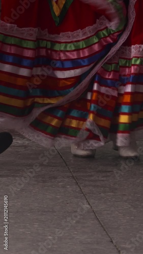 Man and woman dancing traditional Mexican costume colourful skirt feet close up
