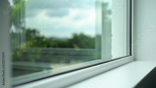 Modern white window frame view of blurred green landscape