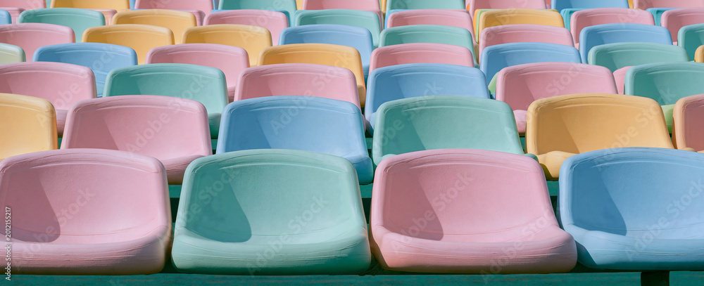 Obraz premium Empty colorful stadium seats in a retro pastel palette