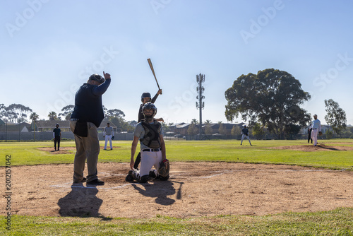 Catcher kneeling at plate as pitcher delivering pitch, animated strike zone tracing path for strike