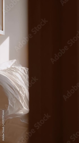 Young woman peeks out from under a cozy white duvet in a softly lit bedroom conveying a sense of quiet contemplation and morning serenity