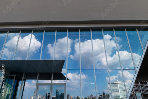 The skyscraper architecture reflected on the glass curtain wall
