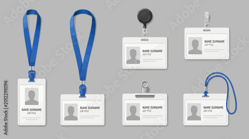 Collection of various employee ID cards with lanyards and clips on a gray background