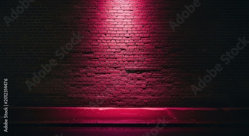 A dark brick wall with a pink light shining on it in the night